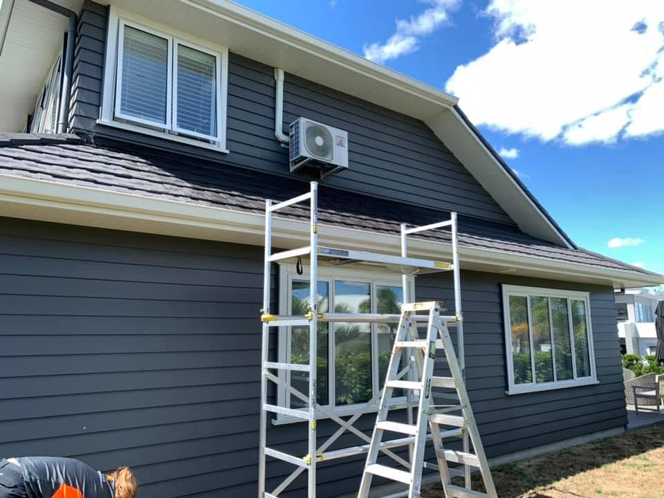 Two story heat pump install with scaffolding and wall brackets
